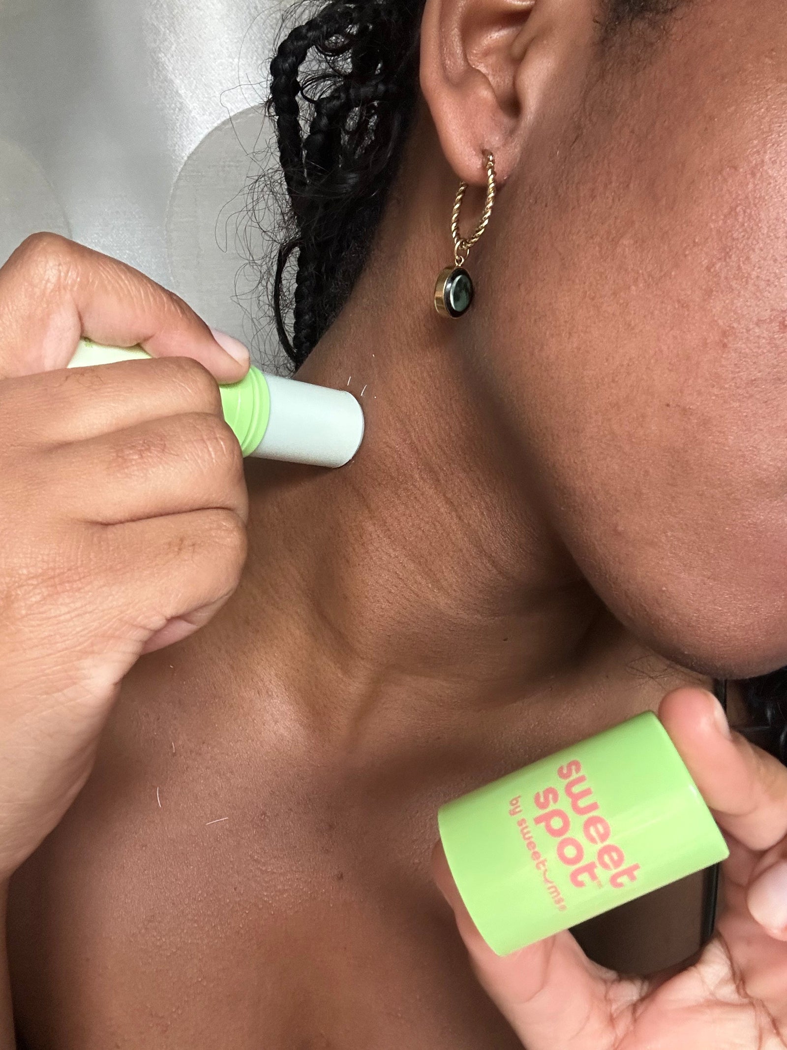 woman applying watermelon sweet spot fragrance on her neck