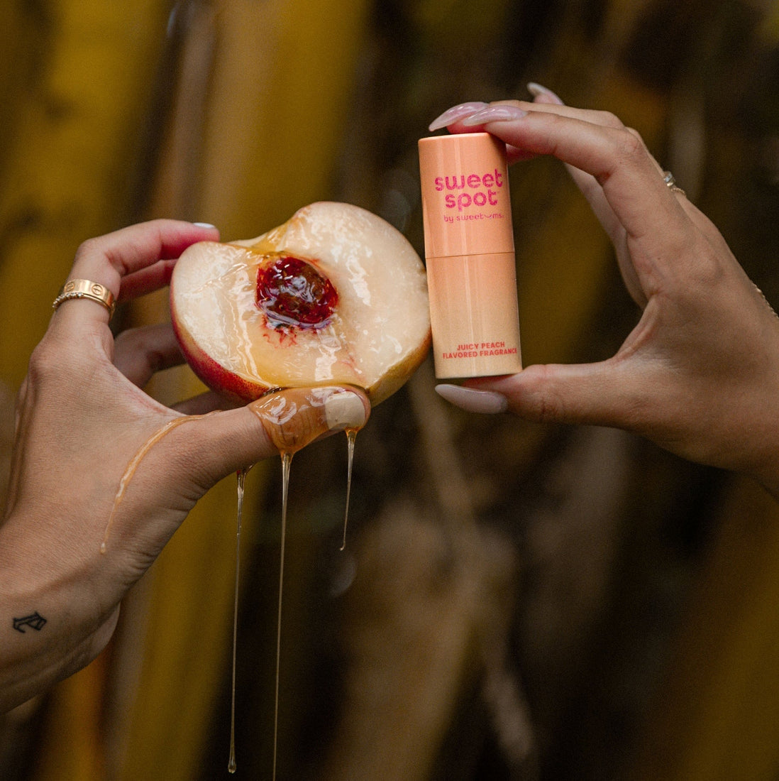 Sweet Spot Juicy Peach flavored fragrance next to a juicy peach