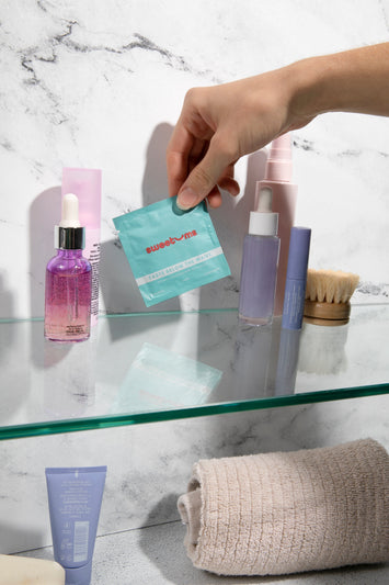 Sweetums Intimate wipe being pulled out of a medicine cabinet