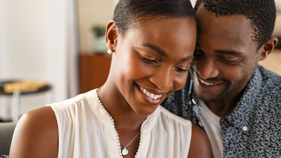 man and woman smiling together