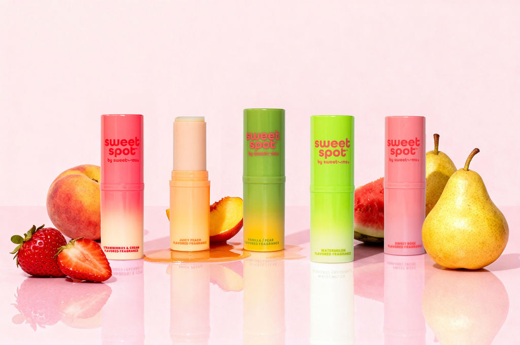 sweet spot flavored fragrances on a pink background with fruit