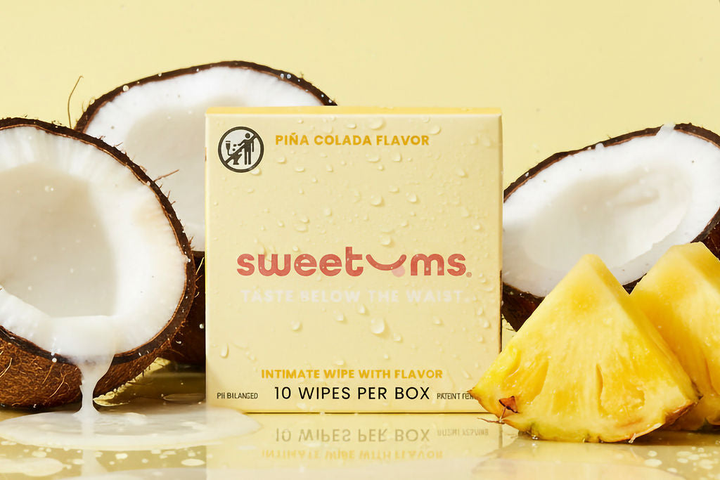 pina colada sweetums wipes with pineapple and coconuts on a yellow background