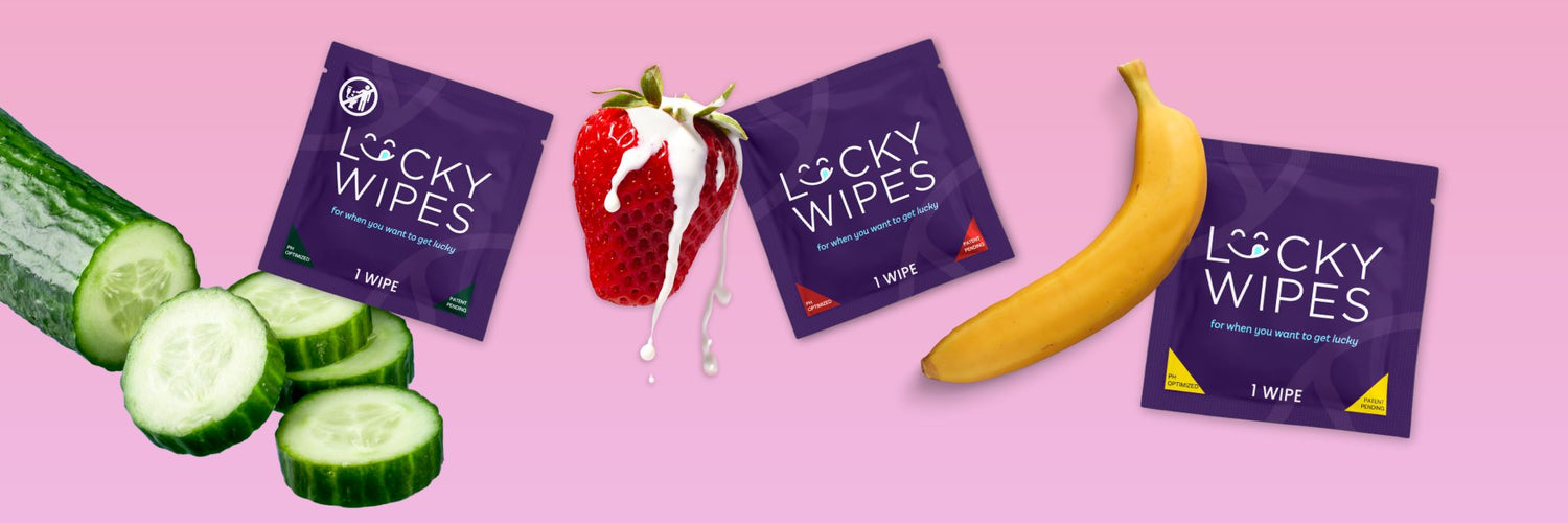 several lucky wipes with fruit on a pink background