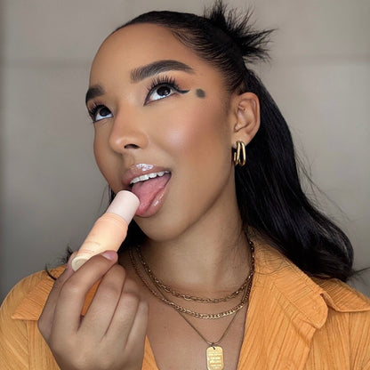 Woman licking juicy peach sweet spot solid flavored fragrance stick