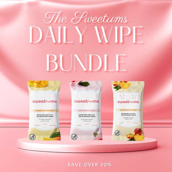 Three packages of 'The Sweetums Daily Wipe Bundle' feminine wipes in mango, rose and peach, on a pink background with text.
