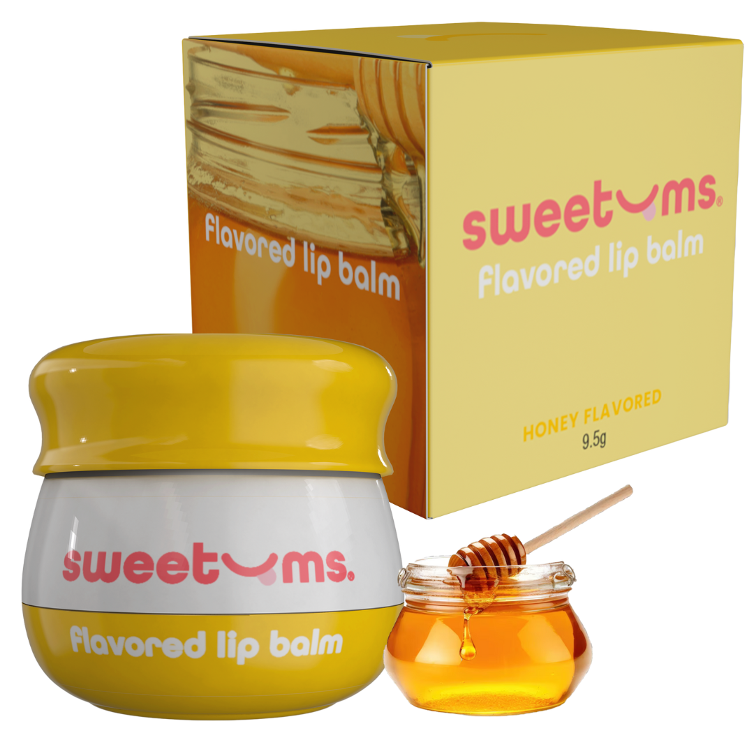 Sweetums honey-flavored lip balm with packaging and a small jar of honey on a white background