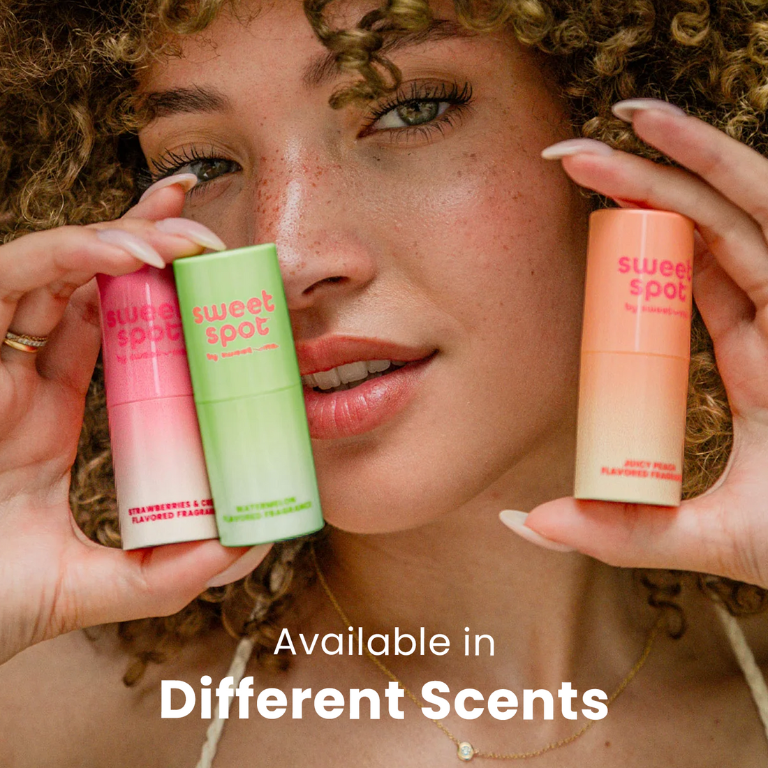 woman holding sweetums sweet spot flavored fragrance near her face showing multiple flavors