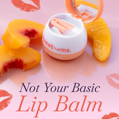 Lip balm with a mirror on peach slices against a pink background with lip prints.