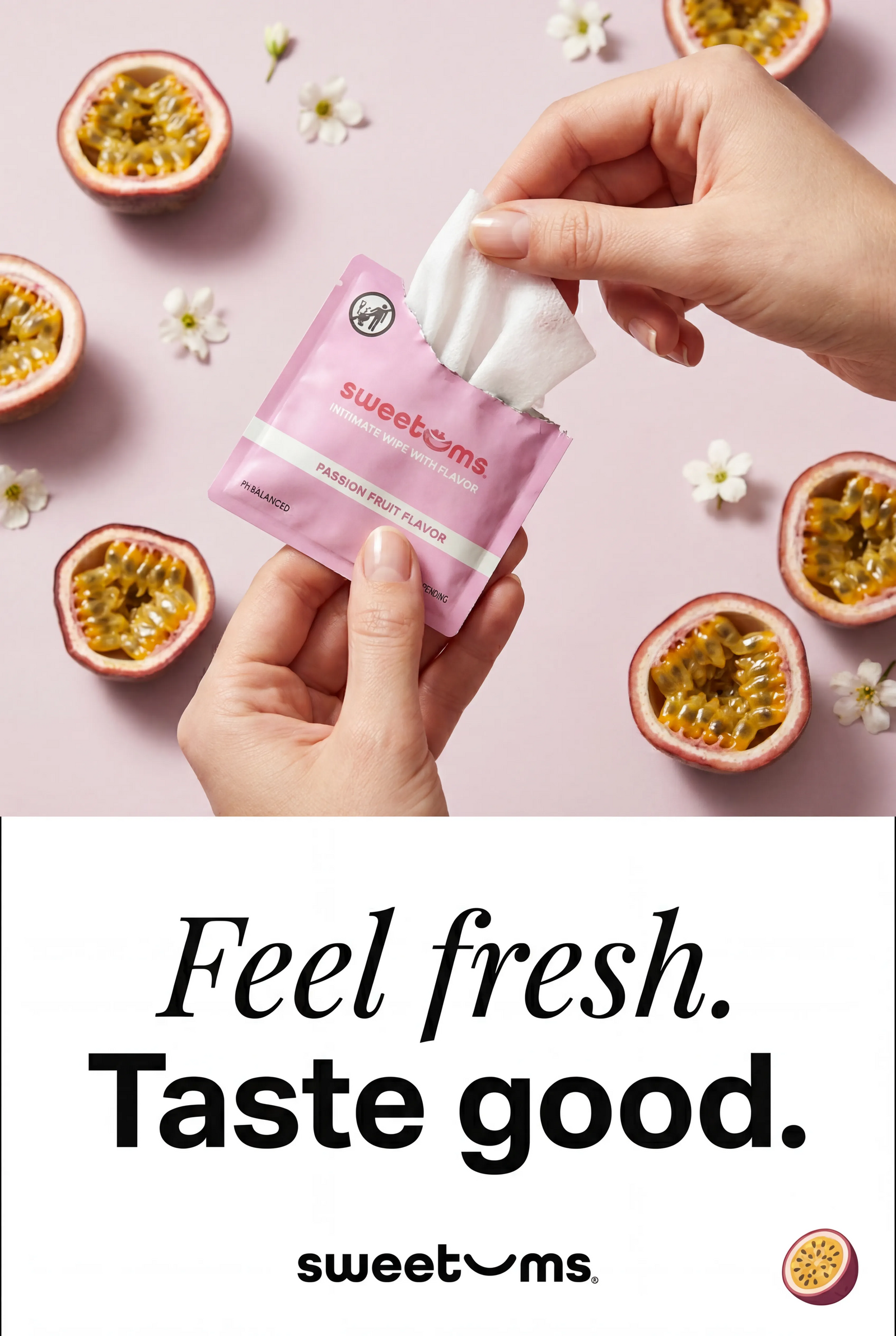 Hands holding a package of sweetems wipes with passion fruit halves and flowers on a pink background.