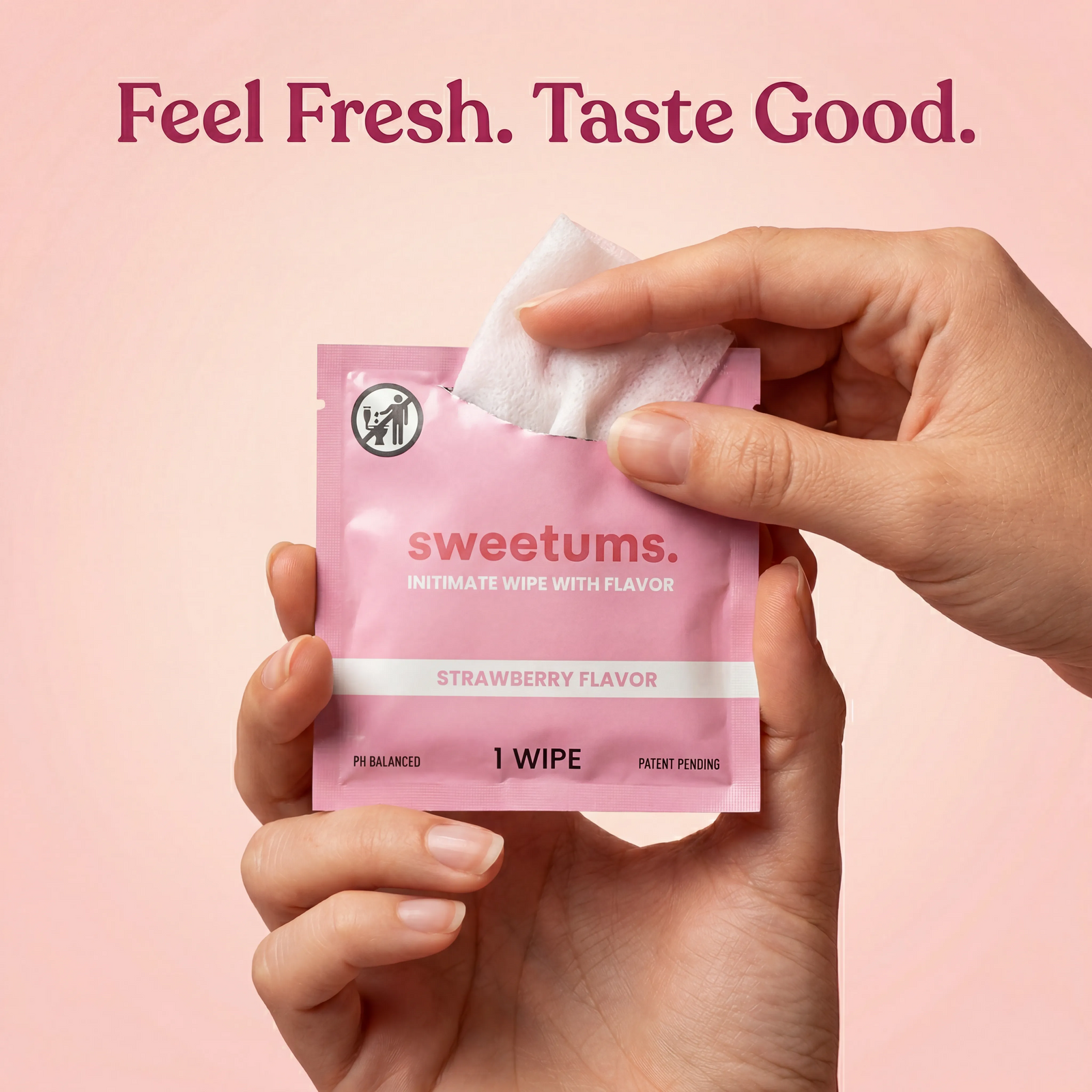 Hand holding a pink 'sweetums' intimate wipe with flavor on a pink background