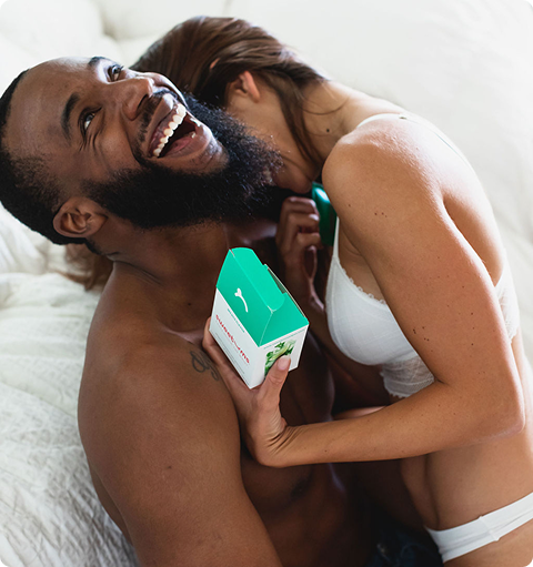 woman and man laughing together while she holds a box of sweetums wipes