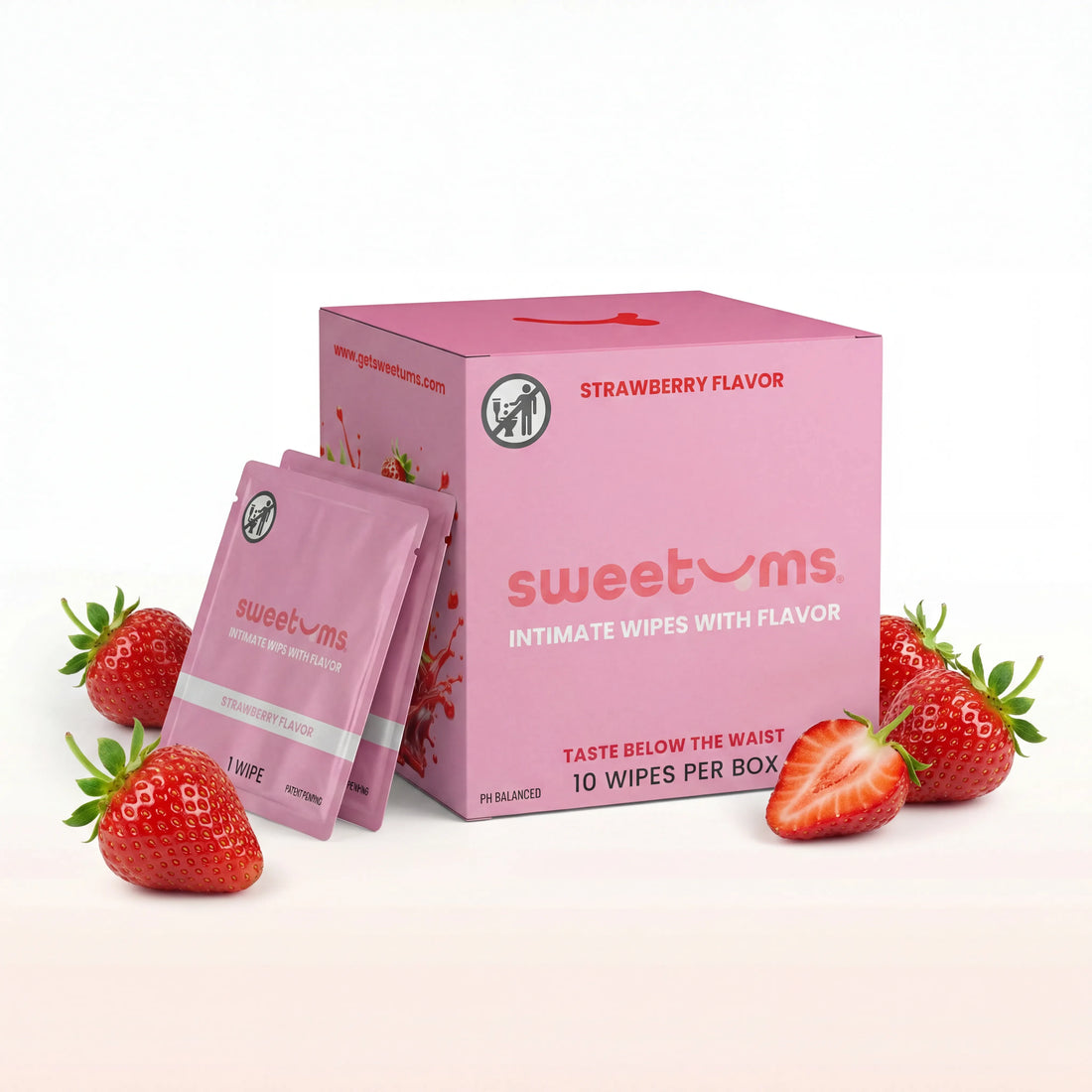 Pink packaging of 'sweetums' strawberry-flavored intimate wipes with two packets and strawberries on a white background.