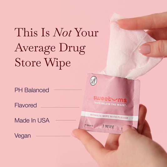 Hand holding a 'sweetums' intimate wipe with product features listed on a pink background
