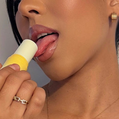 Close-up of a person licking pineapple coconut fragrance with a neutral background