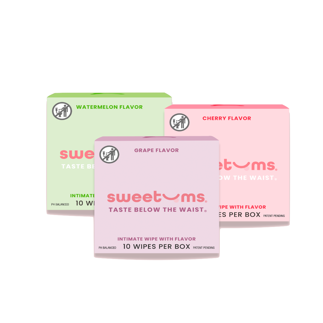 Three boxes of sweetums intimate wipes in watermelon, cherry, and grape flavors on a white background.