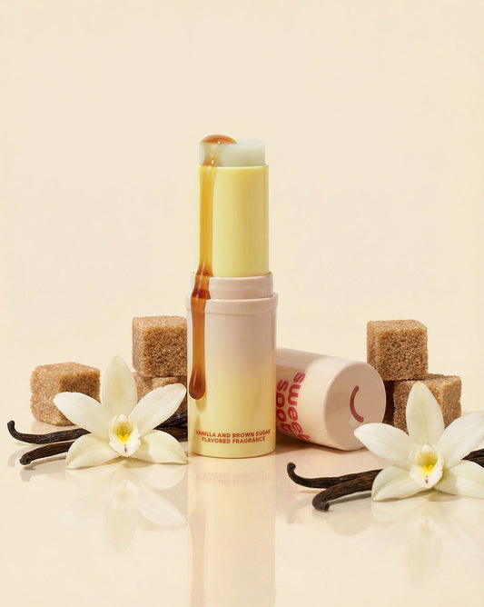 Vanilla-scented  and flavored fragrance product with vanilla beans and flowers on a beige background