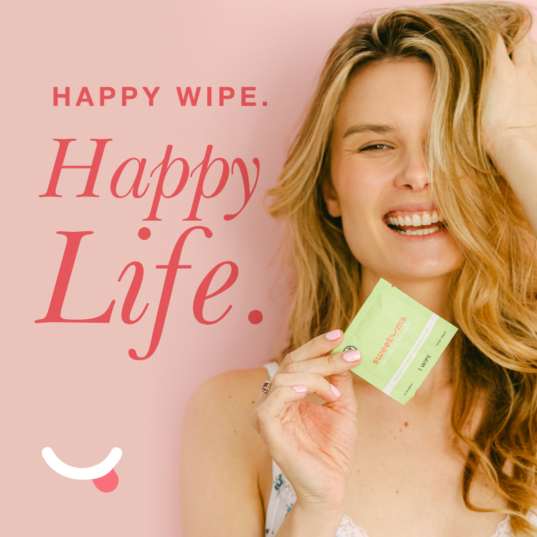 Woman holding asweetums flavored intimate wipe with the words 'happy wipe. happy life.'