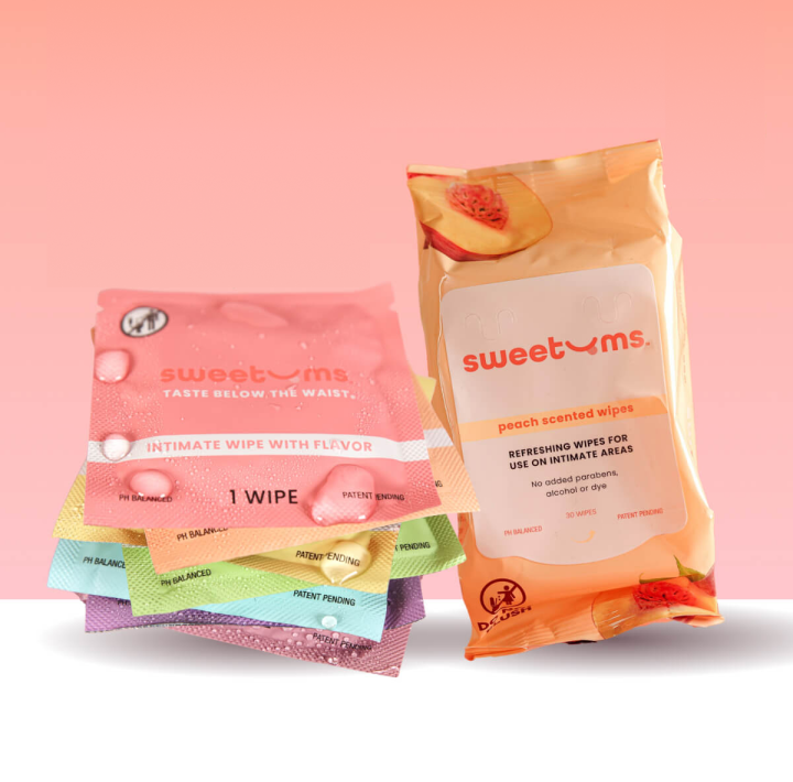 Packages of sweetums intimate wipes on a pink background