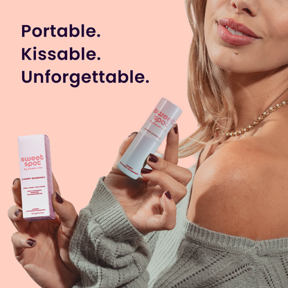 Woman holding two 'sweet spot' products with text 'Portable. Kissable. Unforgettable.' on a pink background