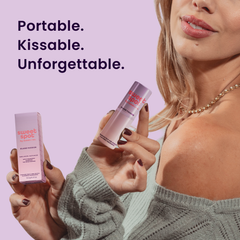Woman holding a passion fruit and guava scented and flavored fragrance stick on a light purple background.