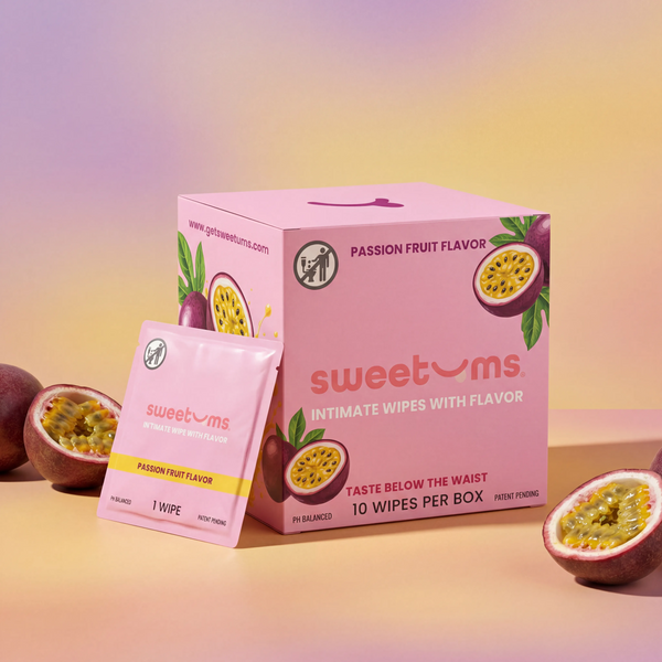 Box and packet of sweetums passion fruit flavored intimate wipes on a gradient background