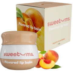 Sweetums peach-flavored lip balm with packaging and peaches on a white background