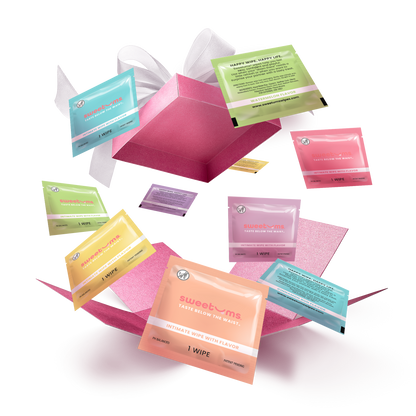 A collection of colorful boxes of Sweetums intimate wipes floating in the air with a open box at the center.